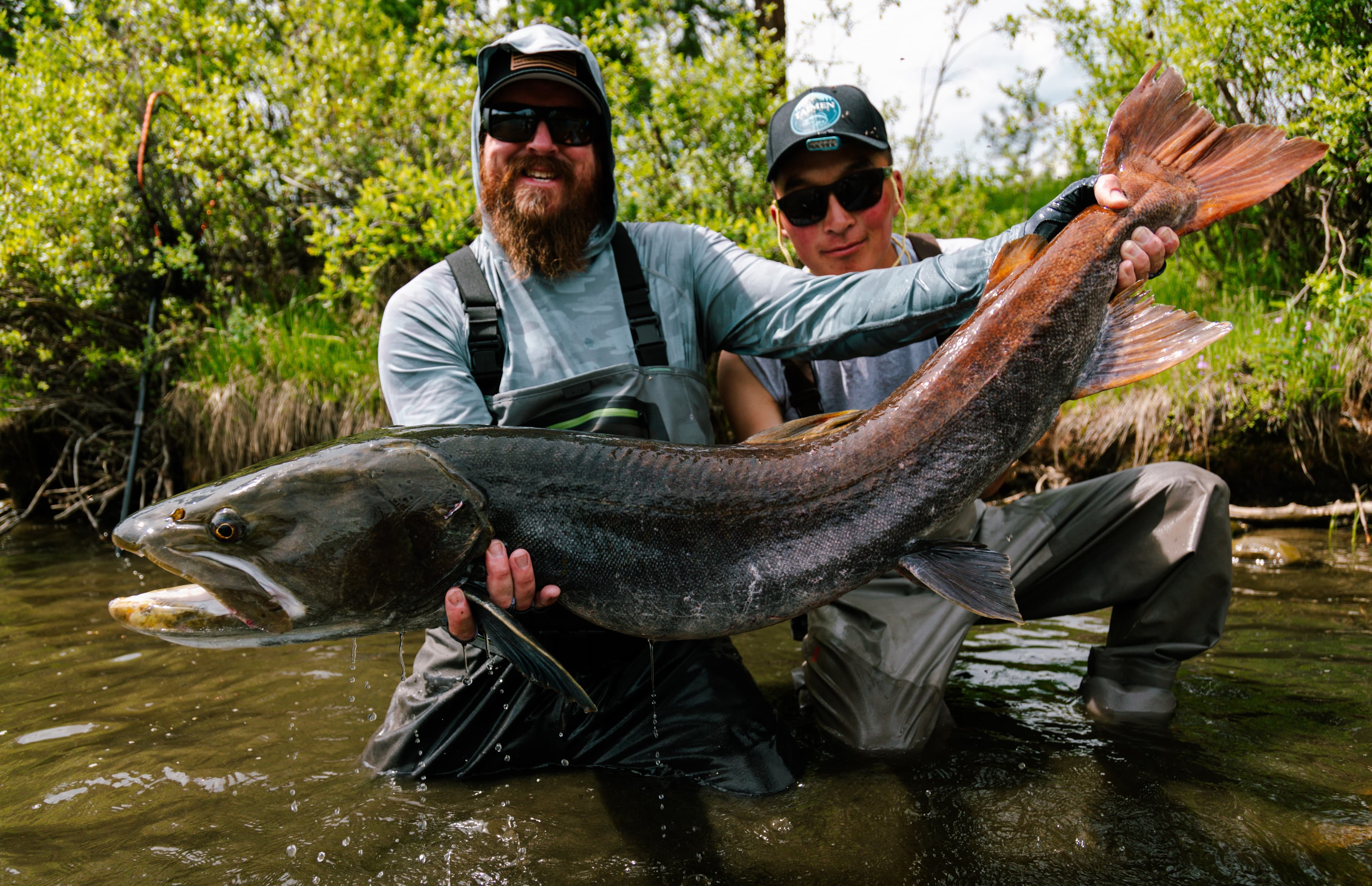 Guide and client holding a taimen catch together